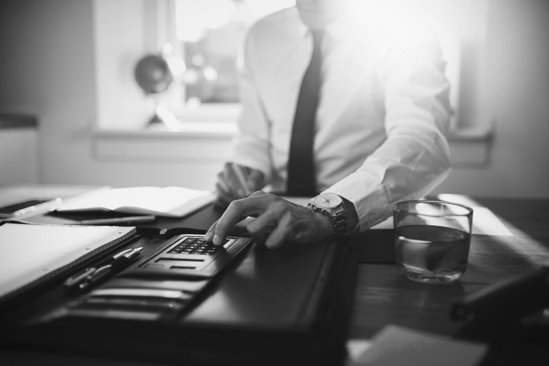 close up, business man or lawyer accountant working on accounts using a calculator and writing on documents