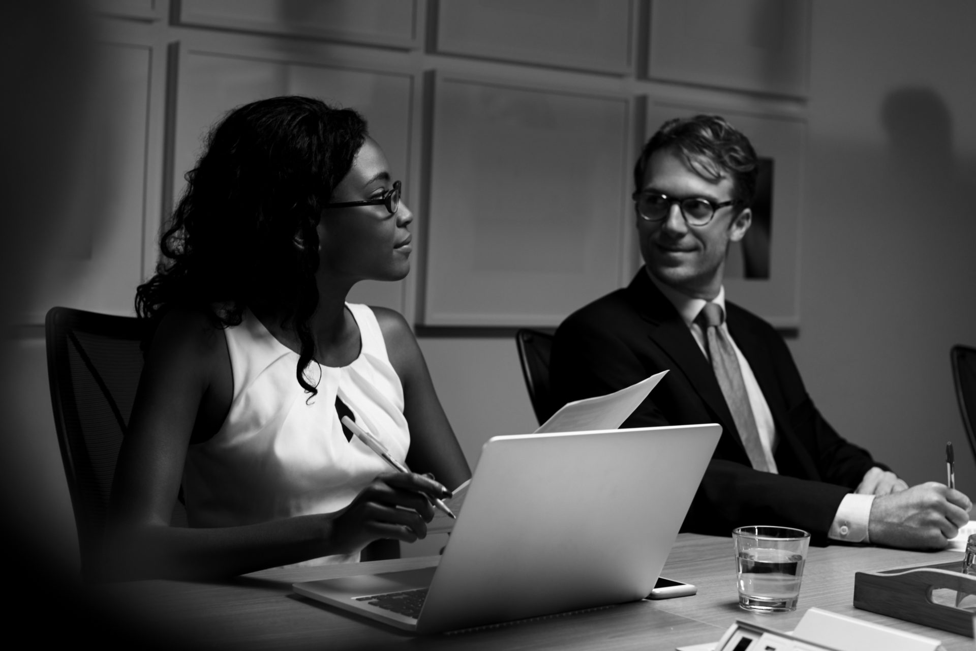 Business colleagues listening at boardroom meeting, close up